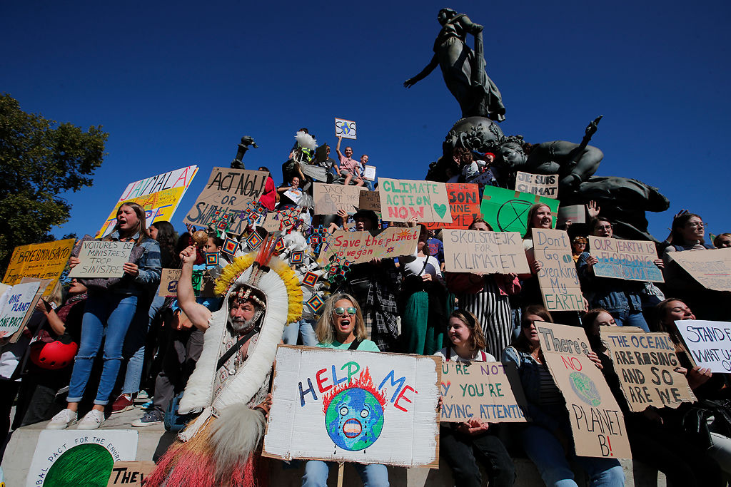 Youths gather at Nation square at the start of a climate demonstration in Paris